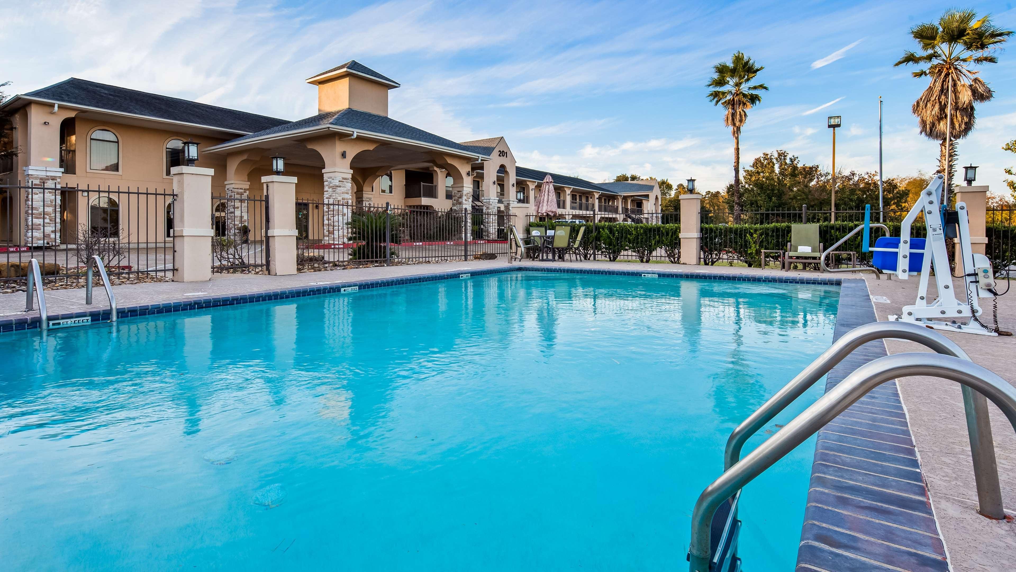 Outdoor pool and hotel exterior at Clarion Pointe